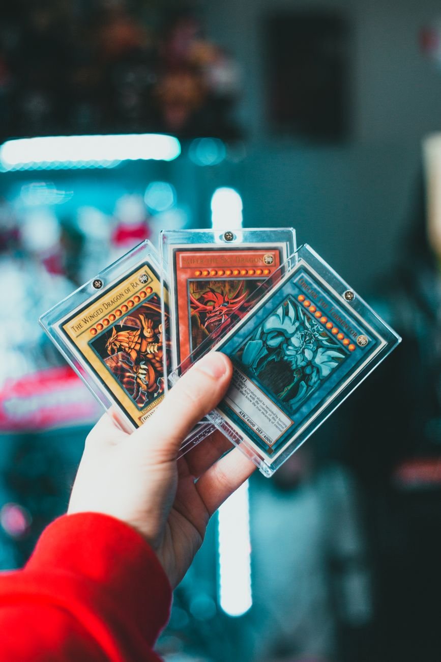 Collector holding trading cards in protective cases — real people making real purchasing decisions